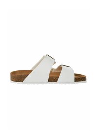 White slide sandal with two adjustable straps, a cork footbed, and a textured rubber sole. The insole is brown and soft to the touch.