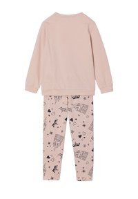 Light pink long-sleeve top with round neck and matching leggings featuring black prints of castles, stars, and hearts on a soft fabric.