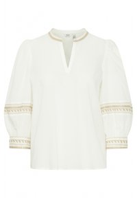 Blouse blanche avec un décolleté en V et des manches bouffantes. Présente une broderie décorative beige le long des poignets et du col. Tissu doux et léger.