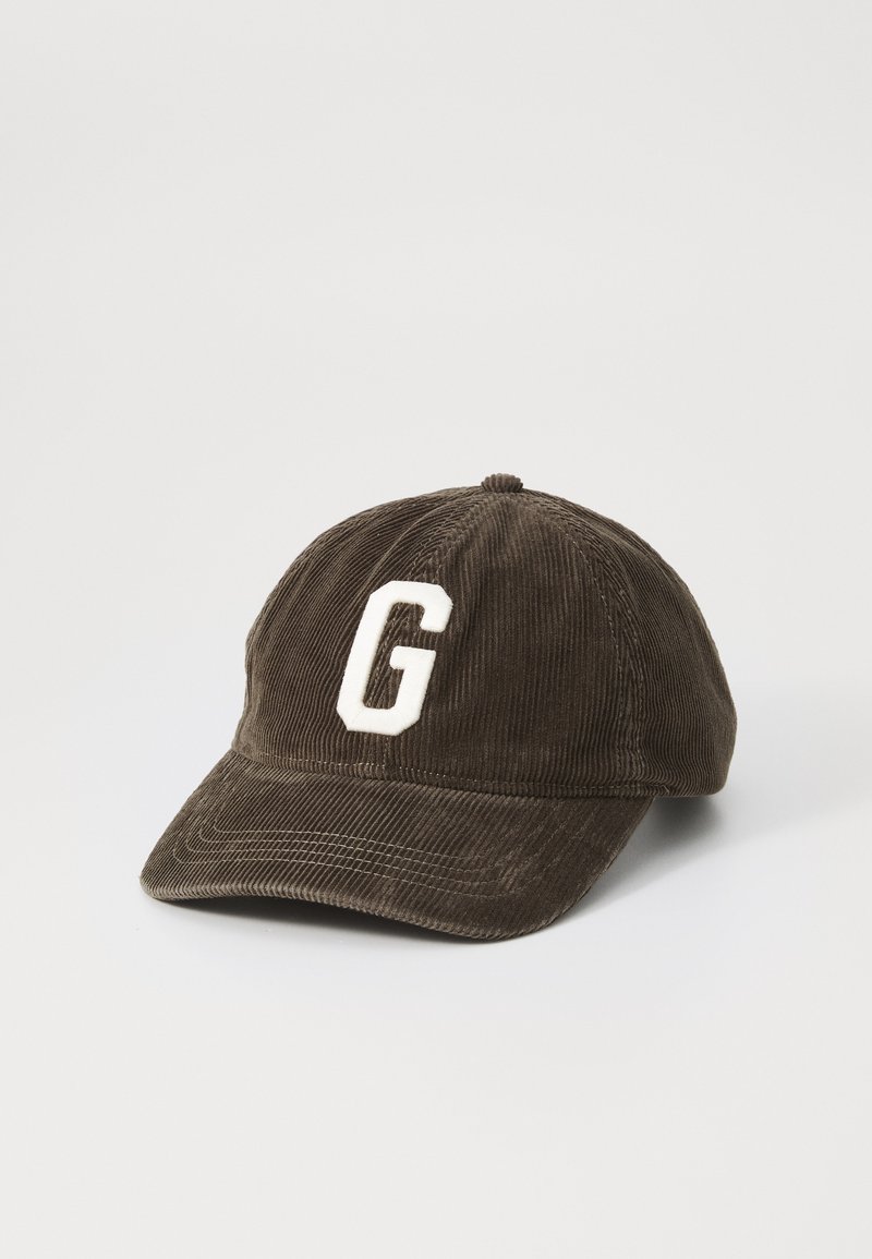 Brown corduroy baseball cap featuring a white "G" patch on the front and a curved brim. The texture is ribbed and soft.