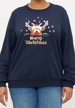 Marineblauer Pullover mit einem rotnasigen Rentier, das einen Weihnachtsmannhut trägt, umgeben von Schneeflocken, und "Frohe Weihnachten" in goldenen Pailletten.