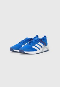 Blue athletic shoes made of mesh and synthetic materials with white stripes and laces, featuring a reinforced heel and textured soles.
