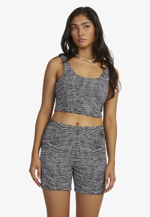 Black and white striped cropped tank top and shorts set, featuring a geometric pattern, lightweight fabric, and relaxed fit.