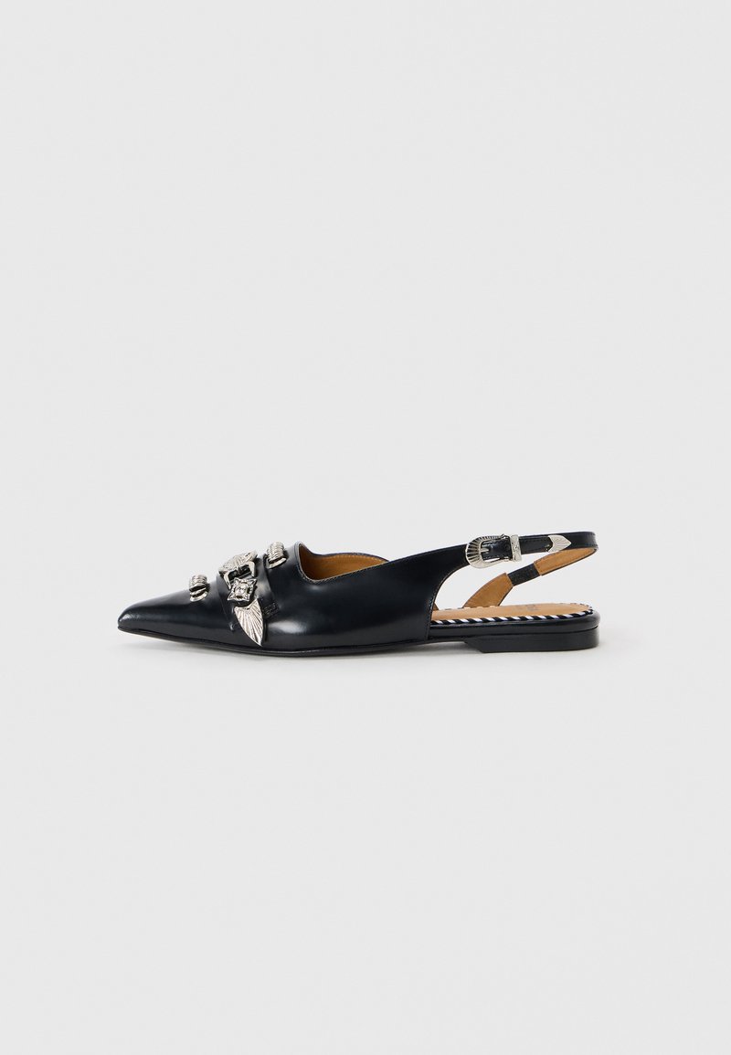 Black leather slingback shoe with pointed toe, adorned with silver hardware and leaf details. Flat sole with striped interior accents.
