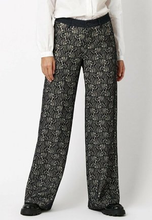 Black wide-leg pants featuring a swirling white pattern, with a smooth texture and a fitted waistband. Complete with a subtle button closure.