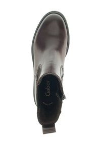 Bottines en cuir marron avec des panneaux élastiques sur les côtés, bout arrondi et une languette à l'arrière. L'intérieur est doté d'un revêtement doux et d'un logo de la marque.