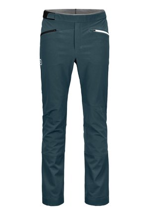 Dark teal softshell pants with a smooth texture, featuring two zippered pockets and a black accent on the waistband. Detailed stitching visible.