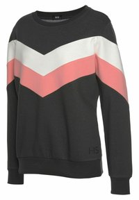 Sudadera negra con un diseño en forma de chevrón en rosa y blanco. Confeccionada en tejido suave y con puños y dobladillo acanalados. Etiqueta de la marca visible.