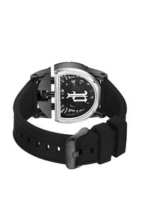 Czarny zegarek na gumowym pasku z elegancką srebrno-czarną kopertą. Posiada przezroczystą tarczę z misternym wzorem i wodoodporność na poziomie 5 ATM.