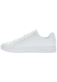 Sneakers bianchi con una finitura liscia, chiusura con lacci e suola bianca testurizzata. Presentano sottili righe laterali e un design minimalista.