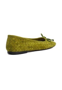 Olive green suede flat shoe with woven texture, rounded toe, and decorative bow on top, shown from the side on a white background.