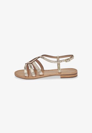 Sandal in oro metallizzato con molteplici fasce sottili e una cinghia alla caviglia con fibbia. Soletta in pelle naturale e suola texturizzata.