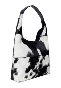 Svart och vit kohud axelväska med ett slätt läderband, som har en lapptäckedesign och mjuk textur.