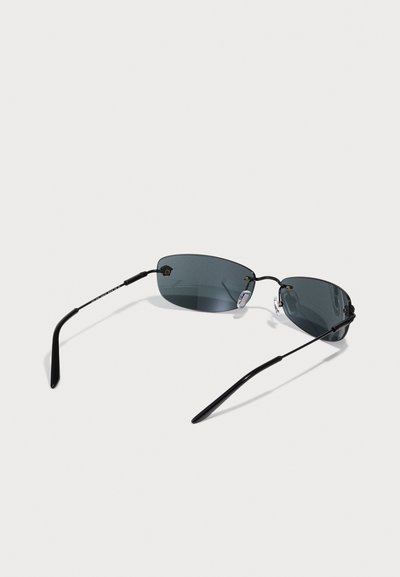 Sunglasses with a smooth black metal frame, dark grey tinted lenses, slim arms, and adjustable nose pads for a secure fit.