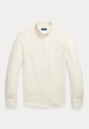 Krémová dlhá košeľa s gombíkovým zapínaním, s gombíkovým golierom a malým vyšívaným logom Polo Ralph Lauren na hrudi.