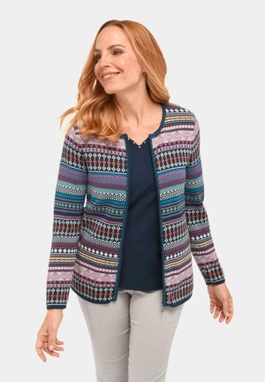 Gebreide cardigan met veelkleurige geometrische patronen in roze, blauw en crème. Voorzijde met rits, geribbelde manchetten en ronde halslijn.