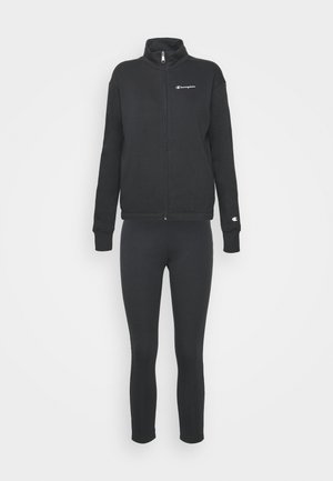 Ensemble de survêtement de la marque Black Champion avec veste zippée et pantalon ajusté, avec petits logos sur la poitrine et le poignet.