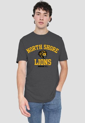 Dark gray cotton t-shirt featuring "NORTH SHORE LIONS" in bold yellow uppercase text, with a lion graphic and "MEANGIRLS" below.