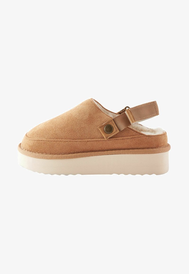 Kreemised nahast puukingad kinnise varbaga, reguleeritava tagavöö ja pehme valge voodriga. Ümmargune talla ja tekstureeritud kummist välistala.