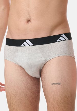 Bajos de algodón grises con una banda elástica negra que presenta acentos en blanco del logo de Adidas; textura suave y diseño ajustado.