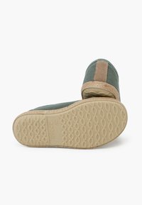 Scarpe slip-on in tela di colore verde scuro con una banda di accento beige. Suola in gomma con un motivo testurizzato; punta rotonda e design flessibile.