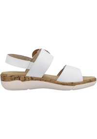 Sandal bianco con due ampie cinghie e una soletta in sughero. Presenta una suola testurizzata e un tacco basso e robusto. Design semplice e funzionale.