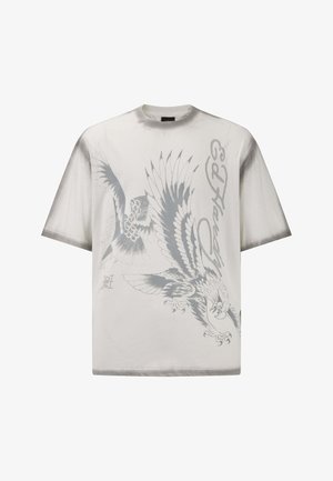 Maglietta bianca a maniche corte con grafiche di aquila e uccelli grigie, collo rotondo e vestibilità rilassata. Materiale in cotone morbido con texture liscia.