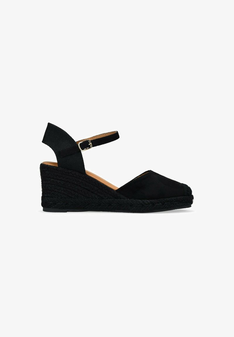 Black wedge espadrille with a fabric upper, an ankle strap with a metal buckle, and a textured jute-wrapped sole.