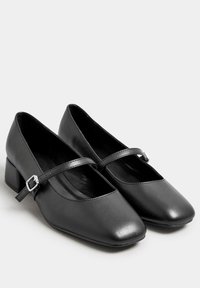 Svart konstläder Mary Jane-skor med fyrkantig tå, låg klack och justerbar rem med en detalj i silverfärg.