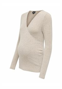 Bluzka ciążowa w jasnym beżu, wykonana z miękkiego materiału. Posiada głęboki dekolt w serek, długie rękawy oraz marszczenia po bokach.
