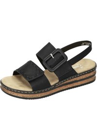 Svart sandal med justerbar rem, bred fotbädd, korkliknande sula och en sydd detalj. Har en stor fyrkantig spänne som accent.