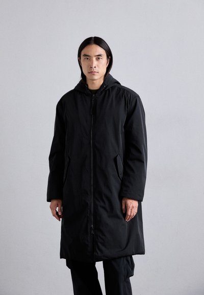 Black hooded parka with a full front zipper, side pockets, and a mid-length cut, featuring a smooth, matte texture.