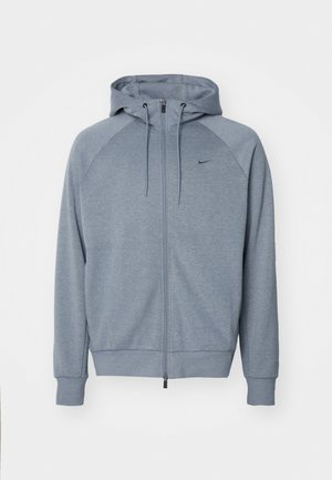 Light gray hoodie with a zippered front, drawstring hood, and raglan sleeves. Features a small black logo on the chest. Soft fabric texture.