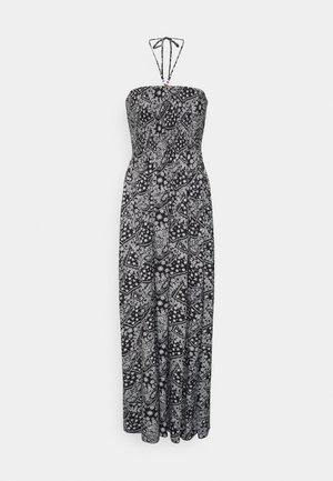 Robe maxi sans bretelles à motif cachemire noir et blanc, avec lien noué au cou en col halter et détails perlés sur les bretelles.