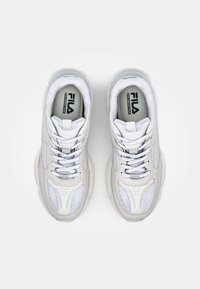 Fila sneakers with a light gray and white mesh upper, textured overlays, padded collar, and flat laces. Rubber sole with contour design.