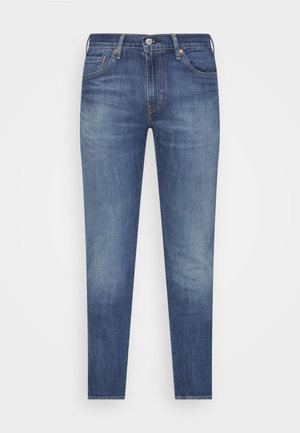 Blaue Denim-Jeans mit schlanker Passform, ausgestattet mit einem klassischen Fünf-Taschen-Design, Knopfverschluss und dezenten Verwaschungen entlang der Beine.