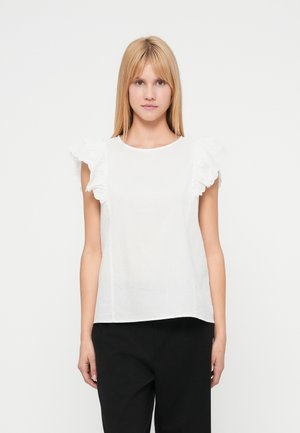 Biały bezrękawnik z falbanami na ramionach, wykonany z lekkiej tkaniny; posiada okrągły dekolt i luźny fason.