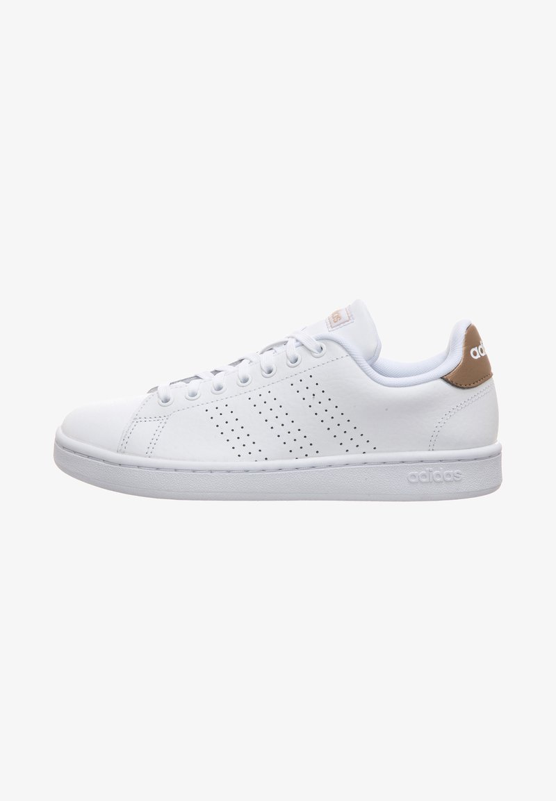 White leather sneaker with a low-top design, featuring perforated stripes, round laces, and a tan heel tab. Brand logo on the side.