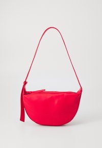 Red leather shoulder bag with a curved shape, a zippered closure, and a thin adjustable strap. Smooth texture with seam detailing.