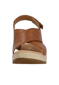 Brown leather sandal with cross straps, open toe, and back strap. Features textured light-colored wedge sole and size 37 marking inside.