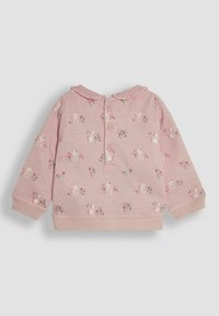 Haut rose à manches longues avec col volanté, arborant un motif de souris et de fleurs. Fermeture à boutons à l'arrière. Tissu doux, coupe décontractée.