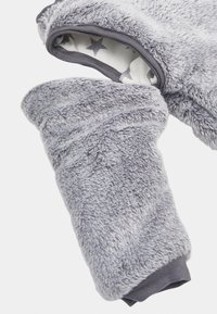 Grey faux fur fabric with a soft texture, featuring a star-patterned inner lining and elastic cuffs for snug fit. Rounded sleeve design.