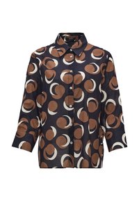 Chemise à manches longues boutonnée avec un fond sombre et de grands motifs abstraits circulaires marron et blancs.