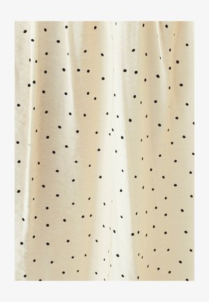 Krémová tkanina s černými puntíky, s jemnou strukturou a lehkým splývavým vzhledem. Puntíky se liší velikostí a jsou rovnoměrně rozmístěny.