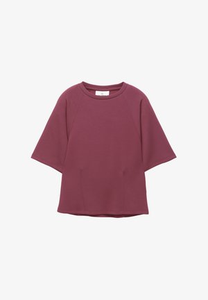 T-shirt ample bordeaux à manches raglan courtes, col rond, avec deux poches latérales et texture lisse. Aucun motif ni élément visible.