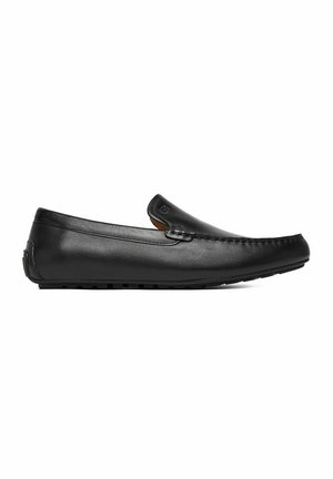 Black leather men's loafer with stitched moc toe, slip-on design, and rubber sole, shown in side profile on white background.