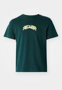 Dark green cotton t-shirt with a crew neckline and short sleeves. Features a yellow graphic design across the chest. Smooth texture.