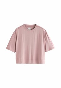 T-shirt cropped di colore rosa chiaro, realizzata in tessuto morbido, con maniche corte, collo tondo e orlo dritto e pulito. Senza fantasie o decorazioni.