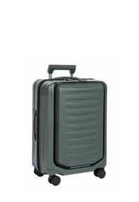 Valise rigide de couleur vert foncé avec des rayures horizontales, poignée télescopique et 4 roues noires pour une mobilité facile. Fermeture éclair, conception robuste.