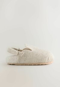 Beige felt slipper with an open back, rounded toe, and side straps. Soft texture and a rubber sole for durability.
